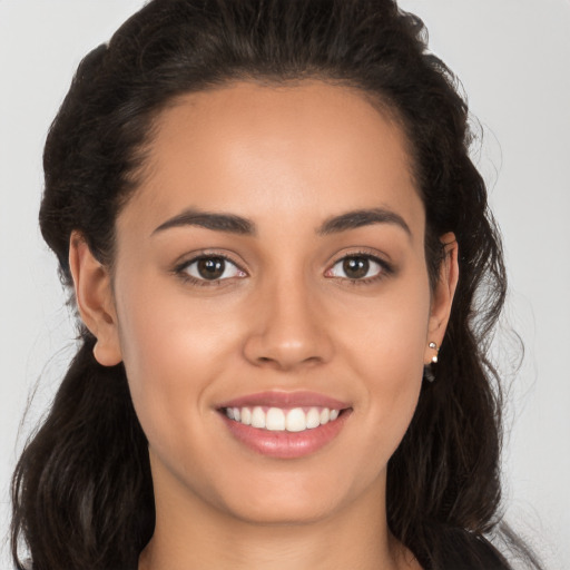 Joyful white young-adult female with long  brown hair and brown eyes