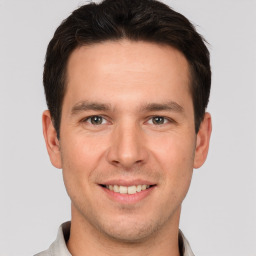 Joyful white young-adult male with short  brown hair and brown eyes