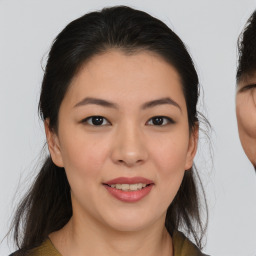 Joyful asian young-adult female with medium  brown hair and brown eyes