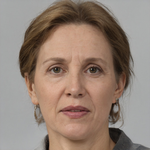 Joyful white adult female with medium  brown hair and grey eyes