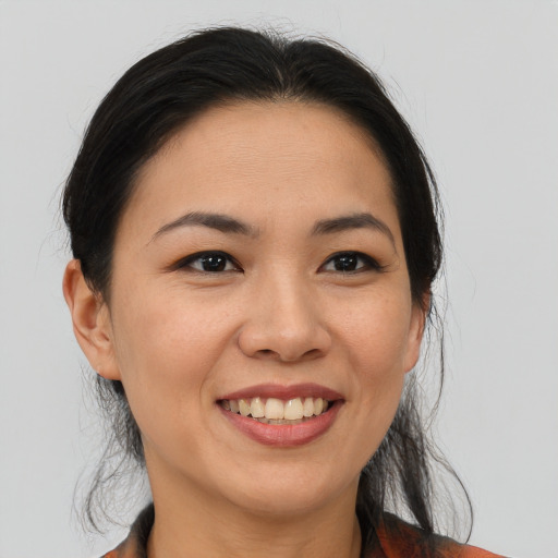 Joyful asian young-adult female with medium  brown hair and brown eyes