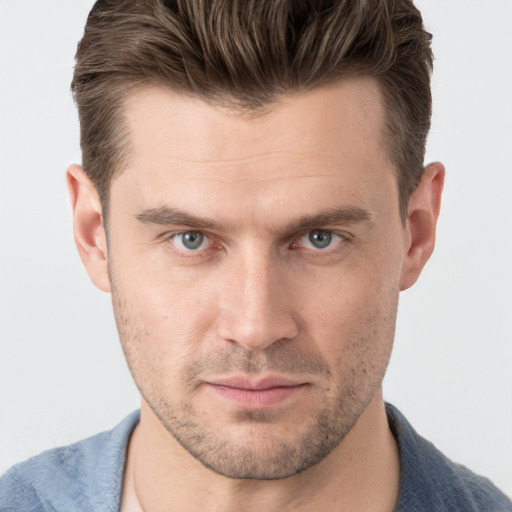 Joyful white young-adult male with short  brown hair and grey eyes