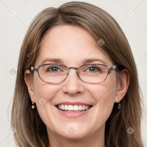 Joyful white adult female with long  brown hair and grey eyes