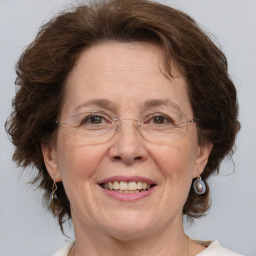 Joyful white middle-aged female with medium  brown hair and brown eyes