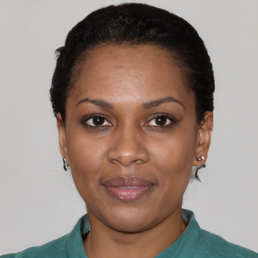 Joyful black young-adult female with short  black hair and brown eyes