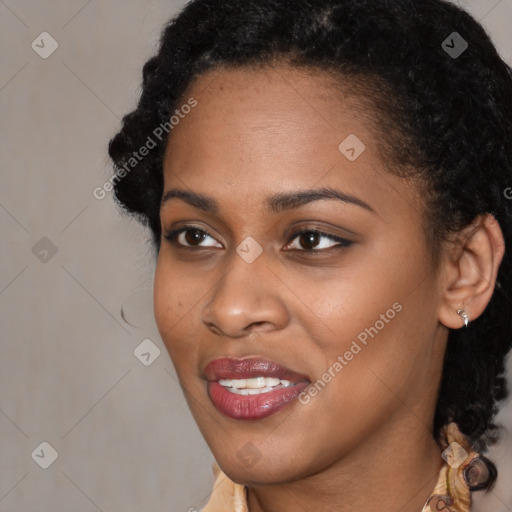 Joyful black young-adult female with long  brown hair and brown eyes