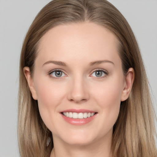 Joyful white young-adult female with long  brown hair and grey eyes