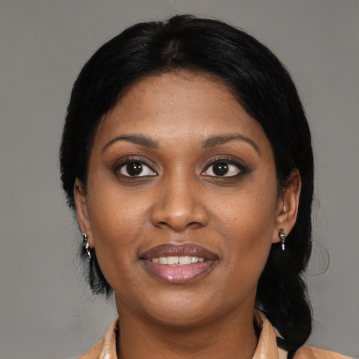 Joyful black young-adult female with medium  black hair and brown eyes