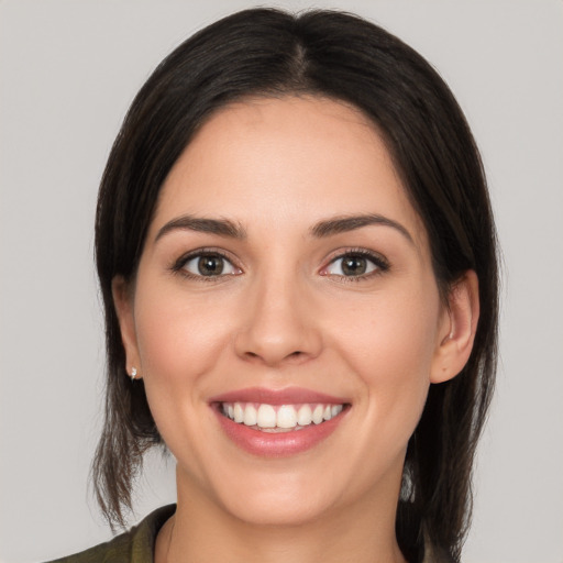 Joyful white young-adult female with medium  brown hair and brown eyes