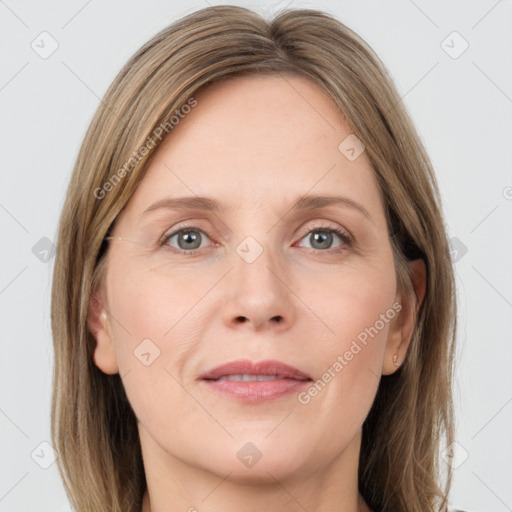 Joyful white adult female with long  brown hair and grey eyes