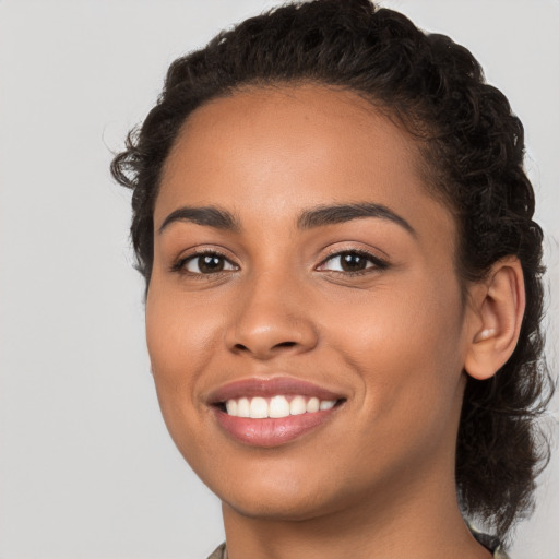 Joyful latino young-adult female with medium  black hair and brown eyes