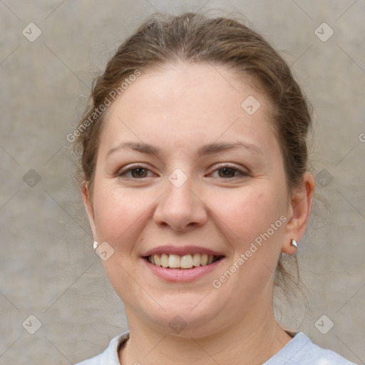 Joyful white young-adult female with medium  brown hair and grey eyes