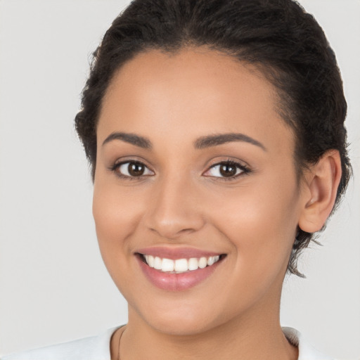 Joyful latino young-adult female with medium  brown hair and brown eyes