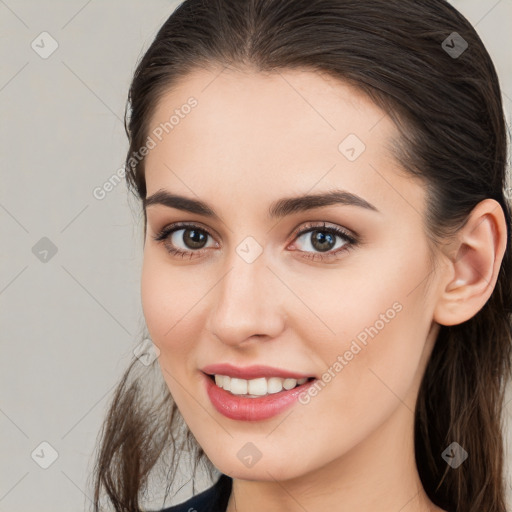 Joyful white young-adult female with long  brown hair and brown eyes