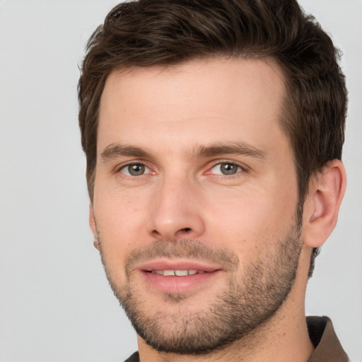 Joyful white young-adult male with short  brown hair and brown eyes