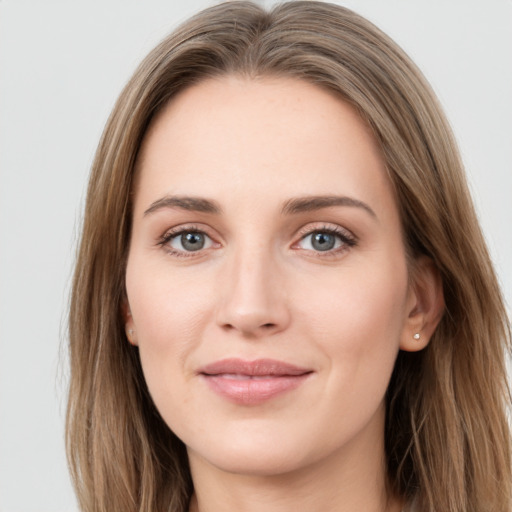 Joyful white young-adult female with long  brown hair and green eyes