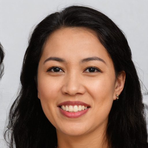 Joyful latino young-adult female with long  black hair and brown eyes