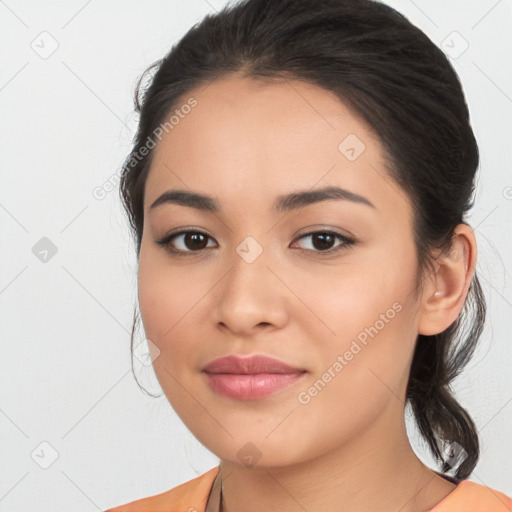 Joyful latino young-adult female with medium  brown hair and brown eyes