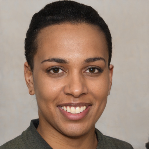 Joyful black young-adult female with short  brown hair and brown eyes