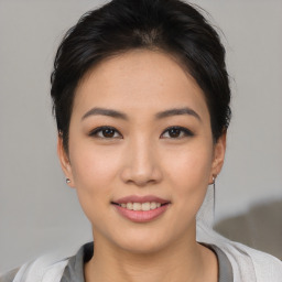 Joyful asian young-adult female with short  black hair and brown eyes