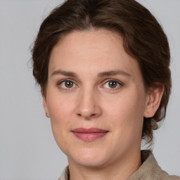 Joyful white adult female with medium  brown hair and grey eyes