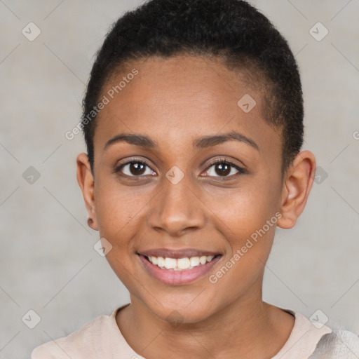 Joyful black young-adult female with short  brown hair and brown eyes