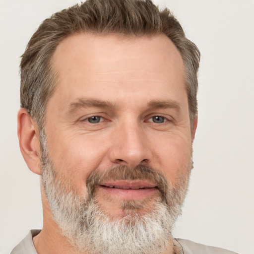 Joyful white adult male with short  brown hair and grey eyes