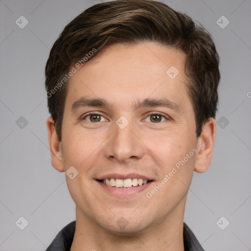 Joyful white young-adult male with short  brown hair and grey eyes