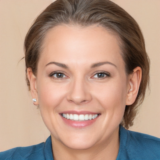 Joyful white adult female with medium  brown hair and brown eyes