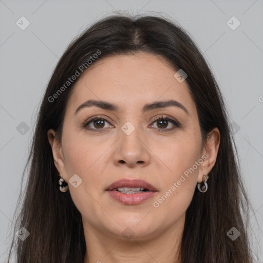 Joyful white adult female with long  brown hair and brown eyes