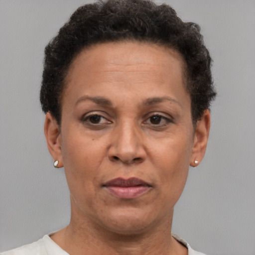 Joyful black adult female with short  brown hair and brown eyes