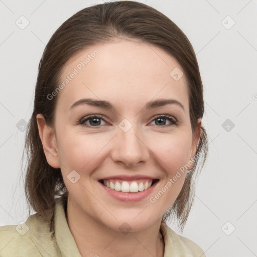 Joyful white young-adult female with medium  brown hair and grey eyes