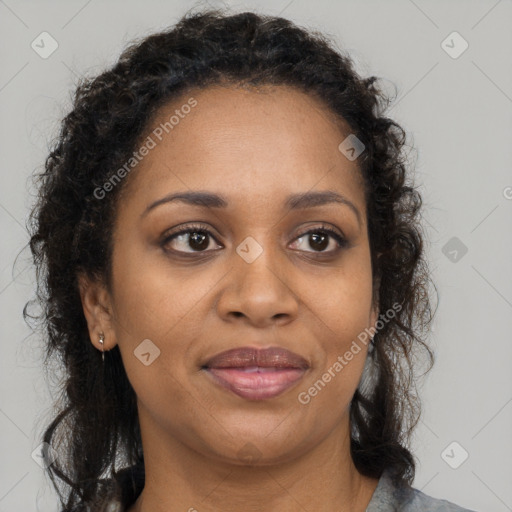 Joyful black adult female with long  brown hair and brown eyes