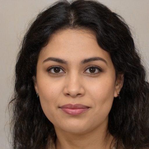 Joyful latino young-adult female with long  brown hair and brown eyes