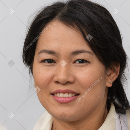 Joyful asian adult female with medium  brown hair and brown eyes