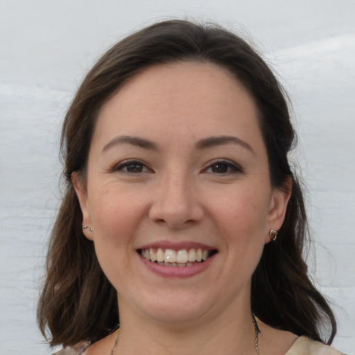 Joyful white young-adult female with medium  brown hair and brown eyes