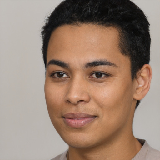 Joyful latino young-adult male with short  black hair and brown eyes