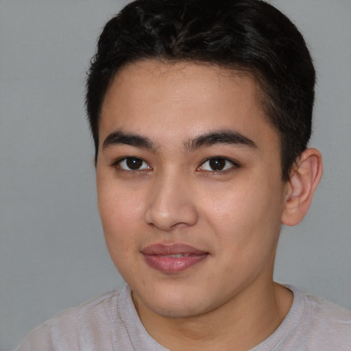 Joyful latino young-adult male with short  brown hair and brown eyes