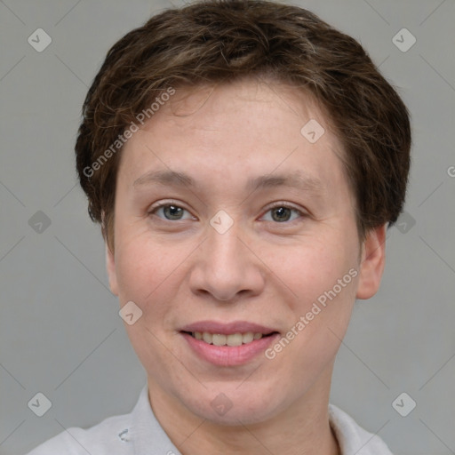 Joyful white adult female with short  brown hair and grey eyes