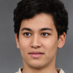 Joyful latino young-adult male with short  brown hair and brown eyes