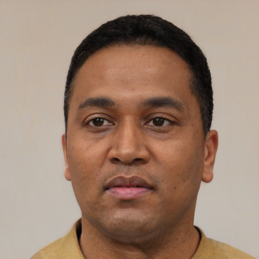 Neutral latino young-adult male with short  black hair and brown eyes