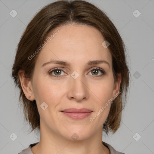 Joyful white adult female with medium  brown hair and grey eyes