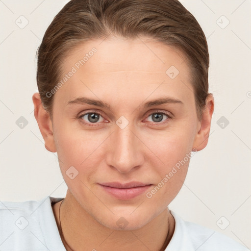 Joyful white young-adult female with short  brown hair and grey eyes