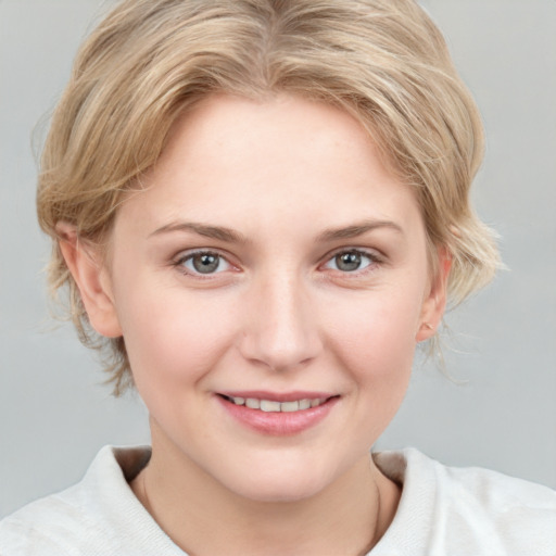 Joyful white young-adult female with medium  blond hair and blue eyes