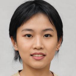 Joyful asian young-adult female with medium  black hair and brown eyes