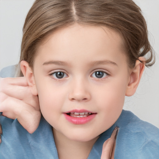 Joyful white child female with short  brown hair and grey eyes