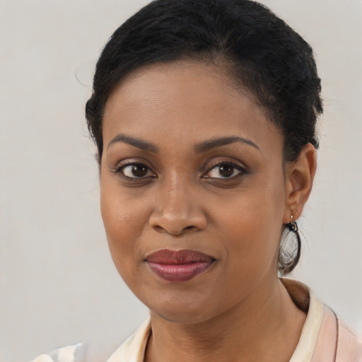 Joyful black young-adult female with medium  brown hair and brown eyes