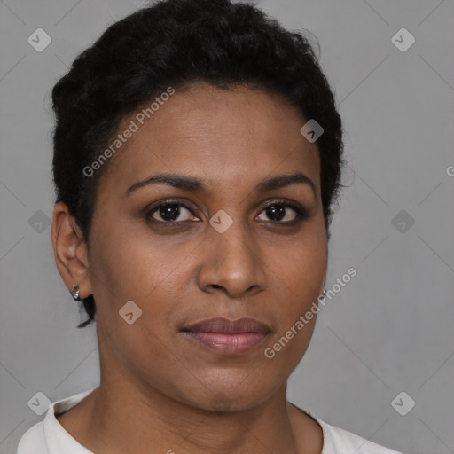 Joyful black young-adult female with short  brown hair and brown eyes