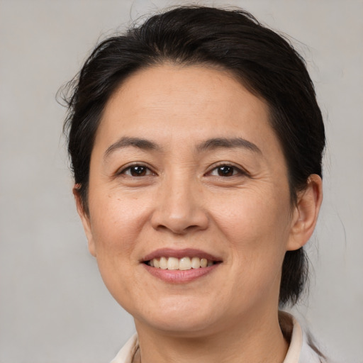 Joyful white adult female with medium  brown hair and brown eyes