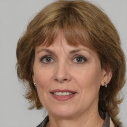 Joyful white adult female with medium  brown hair and grey eyes